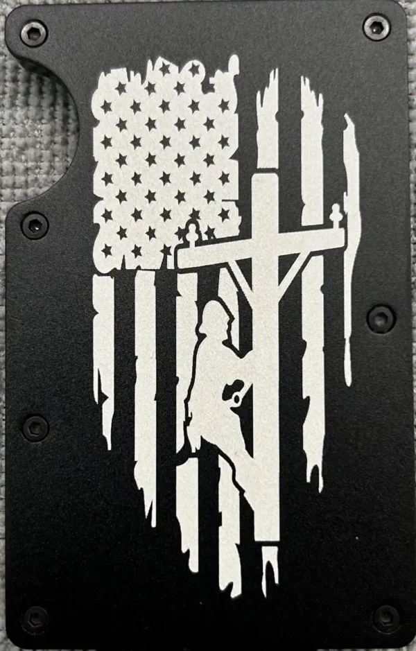 American flag with lineman on pole